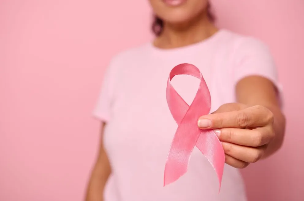 close-up-hand-woman-pink-t-shirt-holding-pink-ribbon-world-cancer-day-breast-abdominal-cancer-awaren