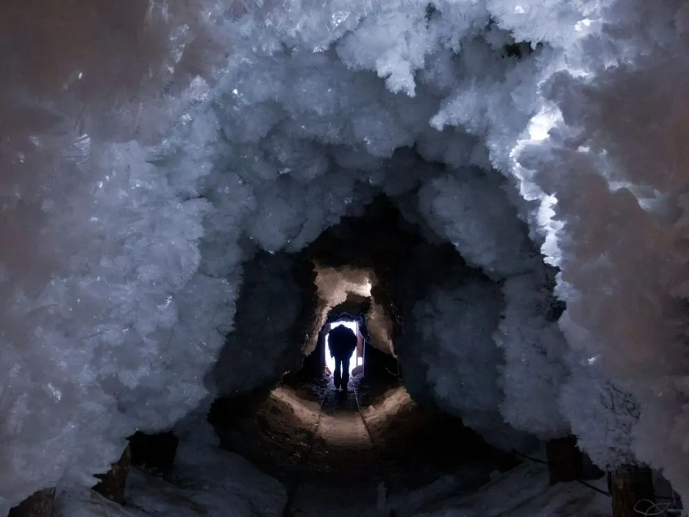 man-walks-through-tunnel-formed-crystals-permafrost-outside-village-tomtor-2979246